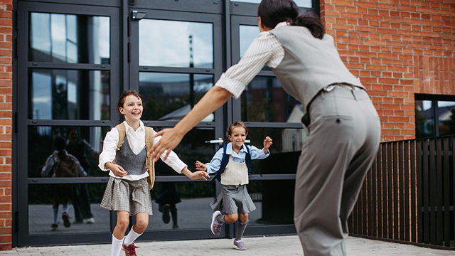 Children run to a woman with open arms.